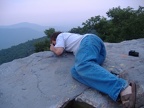 John laying on a rock taking a pic of down below